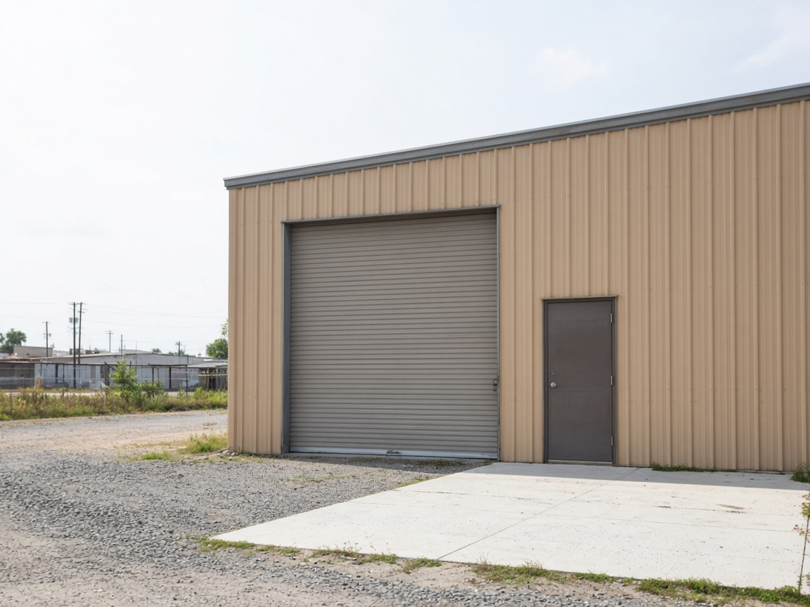 Daylight metal shop exterior with a roll-up door